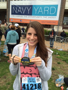 Gina posing with her Broad Street Run medal. 
